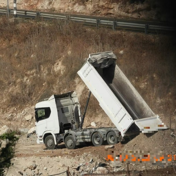 משאית בשטח פתוח משליכה פסולת